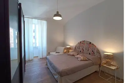 a bedroom with a bed and a chair in it at Casa Filiberto in Rome