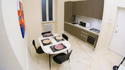 a kitchen with a table and chairs with food on it at RESIDENZA ROSA in Rome
