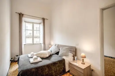 a bedroom with a bed and a window at Suite Experience Termini Station Apartment in Rome