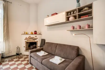 a living room with a couch and a fireplace at Suite Experience Termini Station Apartment in Rome