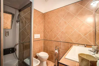 a bathroom with a toilet and a sink and a tub at Suite Experience Termini Station Apartment in Rome