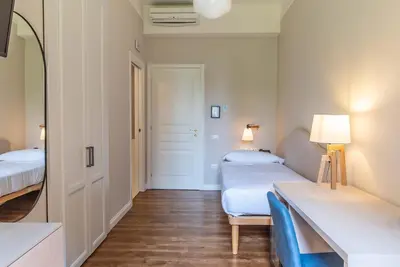 a hotel room with two beds and a mirror at HOTEL DELLE CIVETTE in Rome