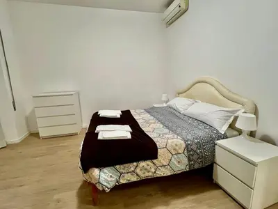 a bedroom with a bed and a dresser with towels at Domus Antonia in Rome