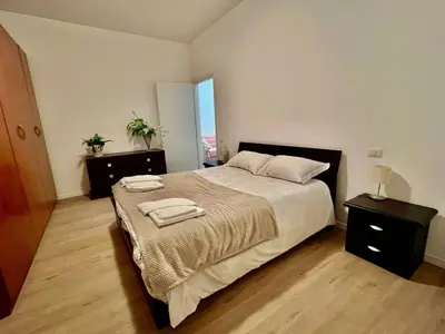 a bedroom with a large bed with two towels on it at Domus Antonia in Rome