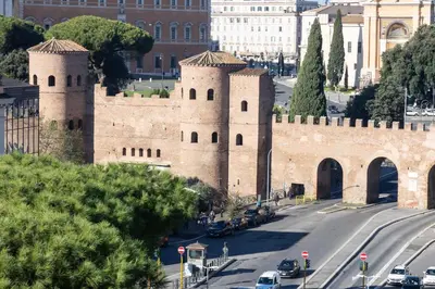 a building with two towers on a city street at Laterano View by Rental in Rome in Rome