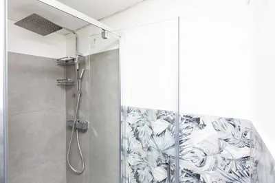 a shower with a glass door in a bathroom at Laterano View by Rental in Rome in Rome