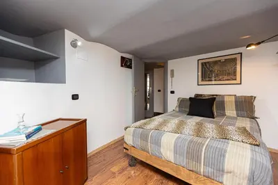 a bedroom with a bed and a wooden dresser at Pantheon by Rental in Rome in Rome