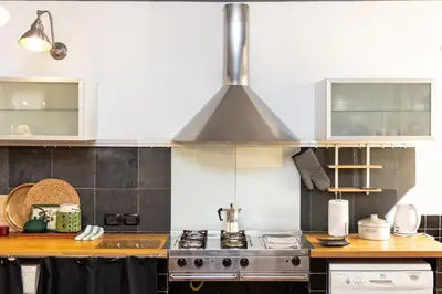 a kitchen with white cabinets and a stove at Pantheon by Rental in Rome in Rome