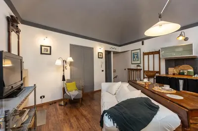 a living room with a white couch and a tv at Pantheon by Rental in Rome in Rome