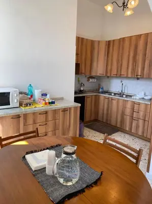 a kitchen with a wooden table with a glass jar on it at Apartment Rome Vatican in Rome