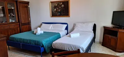 a small room with two beds and a tv at Apartment Rome Vatican in Rome