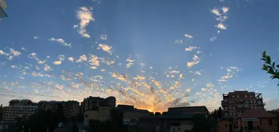 a cloudy sky over a city at sunset at 8380 Lory's House in Rome