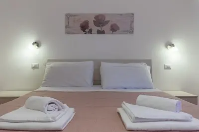 a bedroom with a bed with white towels on it at Evelina in Trastevere in Rome