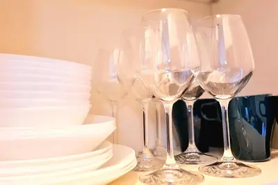 a group of wine glasses and plates on a table at Casa del Vicario al Vaticano in Rome