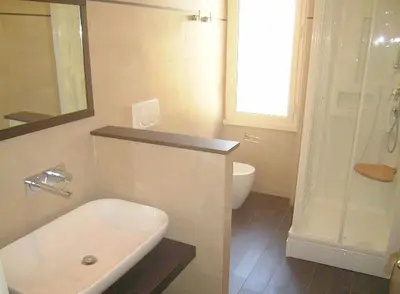 a bathroom with a sink and a toilet and a shower at Cathy Apartment in Rome