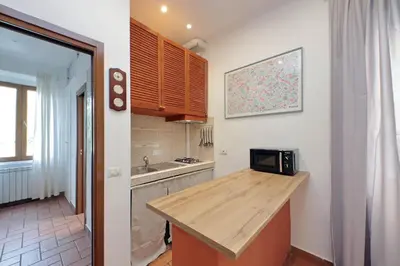 a kitchen with a counter top and a microwave at Homs Apartment In Rome by Halldis in Rome