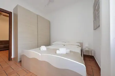 a bedroom with two beds with white sheets and towels at Homs Apartment In Rome by Halldis in Rome