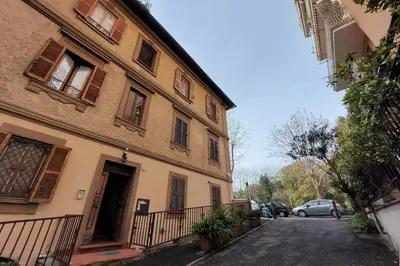 a building on a street with cars parked next to it at Homs Apartment In Rome by Halldis in Rome