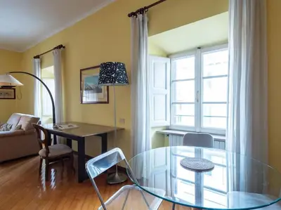 a glass table and chairs in a living room at Porta Pia Elegant Two Bedroom in Rome