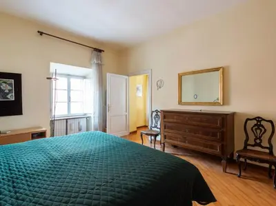a bedroom with a bed and a dresser and a mirror at Porta Pia Elegant Two Bedroom in Rome