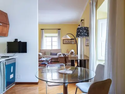 a living room with a glass table and a couch at Porta Pia Elegant Two Bedroom in Rome