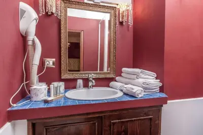 a bathroom with a sink and a mirror at Imperial GuestHouse in Rome