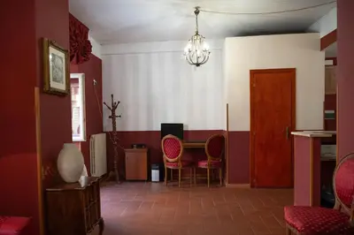a room with a table and chairs and a chandelier at Imperial GuestHouse in Rome