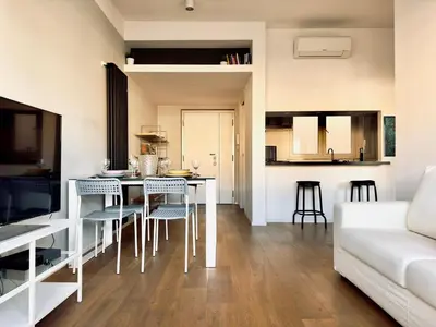 a kitchen and living room with a table and chairs at The Twenty - Villaggio Olimpico apartment in Rome