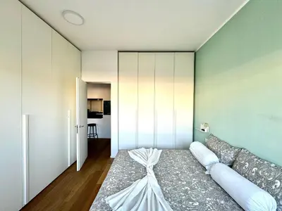 a bedroom with a bed with a dress on it at The Twenty - Villaggio Olimpico apartment in Rome