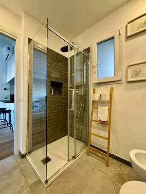 a glass shower in a bathroom with a toilet at The Twenty - Villaggio Olimpico apartment in Rome
