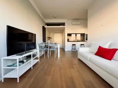 a living room with a white couch and a television at The Twenty - Villaggio Olimpico apartment in Rome