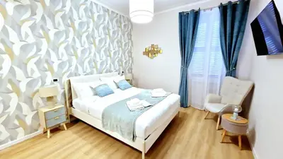a bedroom with a bed and a chair at Baronio Apartment in Rome