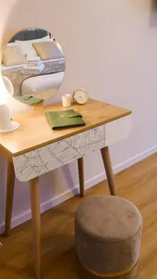 a table with a mirror on it with a stool at Baronio Apartment in Rome