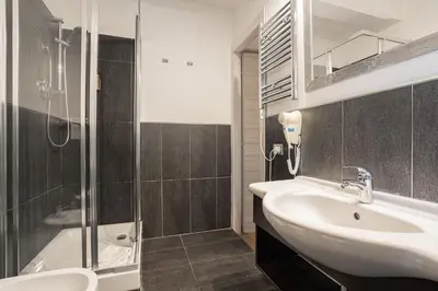 a bathroom with a sink and a shower at Vatican Vittoria Suites - Vatican museums in Rome