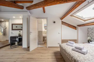 a bedroom with a bed and a desk at Vatican Vittoria Suites - Vatican museums in Rome