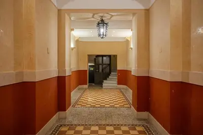 a hallway of a building with a chandelier at Vatican Vittoria Suites - Vatican museums in Rome