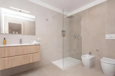 a bathroom with a shower and a toilet and a sink at Vatican Vittoria Suites - Vatican museums in Rome