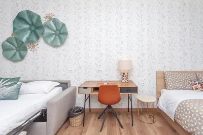 a bedroom with two beds and a desk with a chair at Vatican Vittoria Suites - Vatican museums in Rome