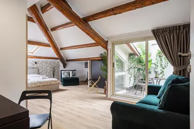 a bedroom with a bed in a room with wooden beams at Vatican Vittoria Suites - Vatican museums in Rome