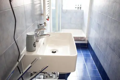 a white sink in a bathroom with a shower at Il Viandante al Pigneto - Parcheggio privato su richiesta in Rome