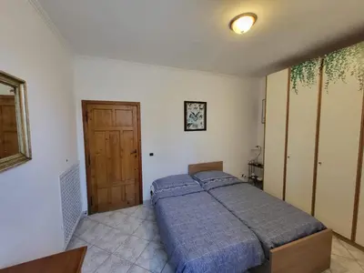 a bedroom with a bed and a wooden door at Ginny's Home in Rome