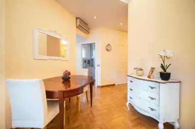 a small white bedroom with a bed and a lamp at St. Peter Hill BuddyRent in Rome