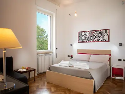 a bedroom with a bed and a window at Room In Roma Isole in Rome