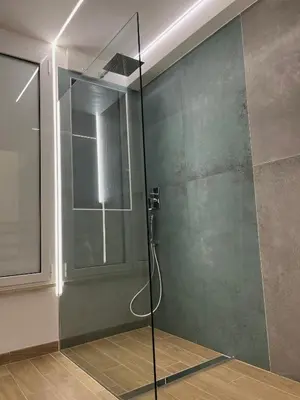 a shower with a glass door in a bathroom at San Pietro love Apartament in Rome