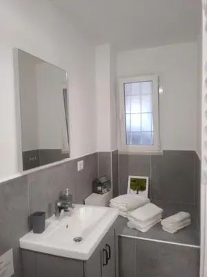 a bathroom with a sink and a mirror at San Pietro love Apartament in Rome