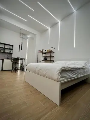 a white bedroom with a bed and a desk at San Pietro love Apartament in Rome