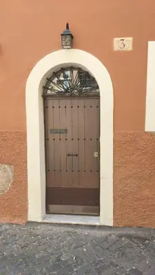 a brown door with a light on top of it at Trastevere Heritage Suite in Rome
