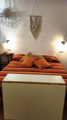 a bed with orange pillows on it in a room at Trastevere Heritage Suite in Rome