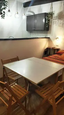 a table and two chairs in a room with a table at Trastevere Heritage Suite in Rome