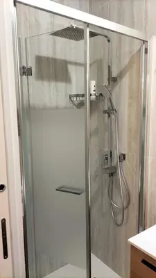 a shower with a glass door in a bathroom at Trastevere Heritage Suite in Rome